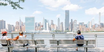 people sitting apart from each other on a bench