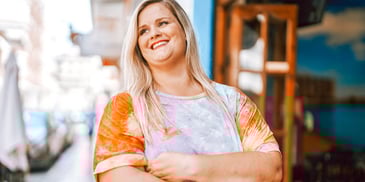 smiling single woman outside her business