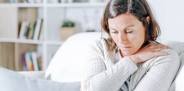 tired and sick woman resting on her couch