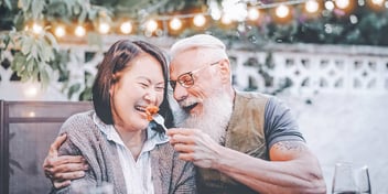Older couple feeds each other on a date after divorce