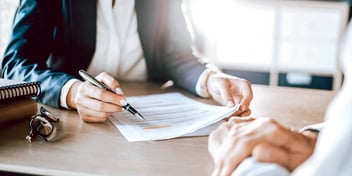 two people reviewing legal paperwork together