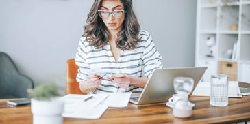 Woman at computer looks over name change paperwork